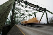 A logging truck drives on the Interstate 5 bridge that spans the Columbia River and connects Portland with southwest Washington state.