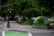 A tent sits at the corner of 3rd Ave. and Main St. in downtown Portland on Thurs., May 20, 2021. The Oregonian