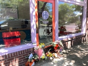 A makeshift memorial of flowers and lemons leans outside Cornet Custard in Southeast Portland on Tuesday.