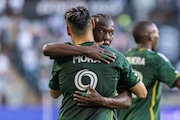 Portland Timbers forward Felipe Mora (#9) hugs teammate Diego Chara after Mora’s goal in the 43rd minute during an MLS match against the Vancouver Whitecaps at Providence Park on Saturday, June 22, 2024.