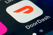 The DoorDash app icon is shown on a smartphone.