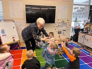 Oregon Gov. Tina Kotek high-fives children during a visit to a school in Vernonia. She is proposing changes to the way the state calculates the amount of money schools receive that she says could add an estimated half a million dollars to the total.