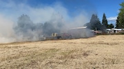 Crews from Forest Grove Fire & Rescue put out a burn pile that caused a wildfire in rural Washington County on Tuesday, July 2.