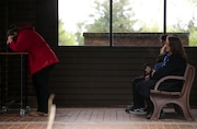 Alyson Henderson (left) cradles the urn containing the remains of her brother Jonathan Henderson as HendersonÕs mother, Sharon Alvarez (right, with flag) looks on.  A funeral service was held for Jonathan Henderson at Willamette National Cemetery on Mon., April 29. 2024.  Henderson, a Marine, died six cays after being hit by a car in downtown Portland on March 12.  