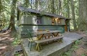 A furnished cabin steps from the Zigzag River at 78830 E. Road 35a #28 in Government Camp is for sale at $299,950.