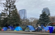 People camp in tents next to the Interstate 405 freeway in Portland, Ore., on March 31, 2023. The city of Portland will decide Wednesday, May 31, 2023, whether to ban homeless camping during daytime hours in most public places. Portland City Council will vote on a measure that would prohibit camping between 8 a.m. and 8 p.m. in city parks and near schools and day cares. (AP Photo/Eric Risberg) AP