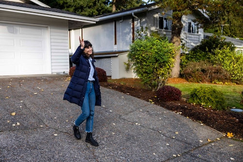 Marie Gluesenkamp Perez is walking down a driveway as she waves to someone off camera.