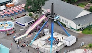 Riders are released and helped out of the AtmosFEAR ride at Oaks Amusement Park on June 14, 2024. The ride stalled and people hung upside down for about 30 minutes in the air before the ride was  lowered. Authorities reported no serious injuries.