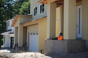 Construction workers take a brake at the neighborhood that has seen multiple properties damaged.