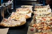 Pies lined up at a MOD Pizza restaurant.