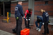 EMT Hunter Endresen (left), paramedic Justin De Jesus (center left) and EMT Mandy Boynton (right), members of Portland Fire & Rescue's CHAT 1 team, approach a potential overdose victim in downtown Portland on Wed., Feb. 7, 2024.