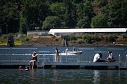 People gathered on a new dock that opened last week in the Willamette River at Cathedral Park under the St. Johns Bridge on Thurs., July 4, 2024. Many had the day off for Independence Day and set out to enjoy the warm weather ahead of a predicted heat wave.