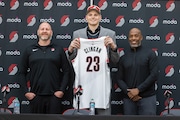 Donovan Clingan, the No. 7 pick of the 2024 NBA draft, poses for a photo with Portland Trail Blazers GM Joe Cronin (left) and head coach Chauncey Billups (right) at the team’s practice facility in Tualatin, Oregon on Saturday, June 29, 2024.