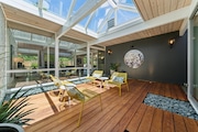 A 1971 Robert Rummer-built house in Beaverton for sale has a glass-enclosed atrium to invite indoor-outdoor living and feeling close to nature.