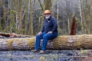 Logger Ken Risseeuw sits on a felled Douglas fir in the forest outside of Grand Ronde that will go on to have a very specific form of arboreal acclaim.